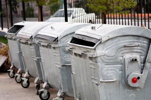 Company van beside commercial waste bins at a business premises